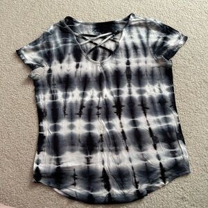 Black and white tie-dye t-shirt with criss-crossed straps across chest.